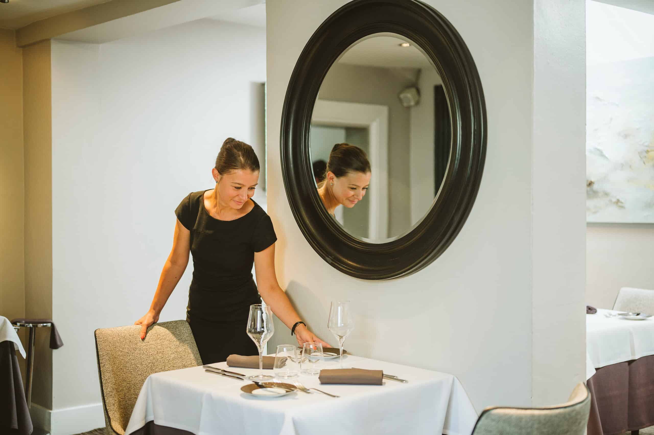 Head Waitress Sets a table in fine dining restaurant