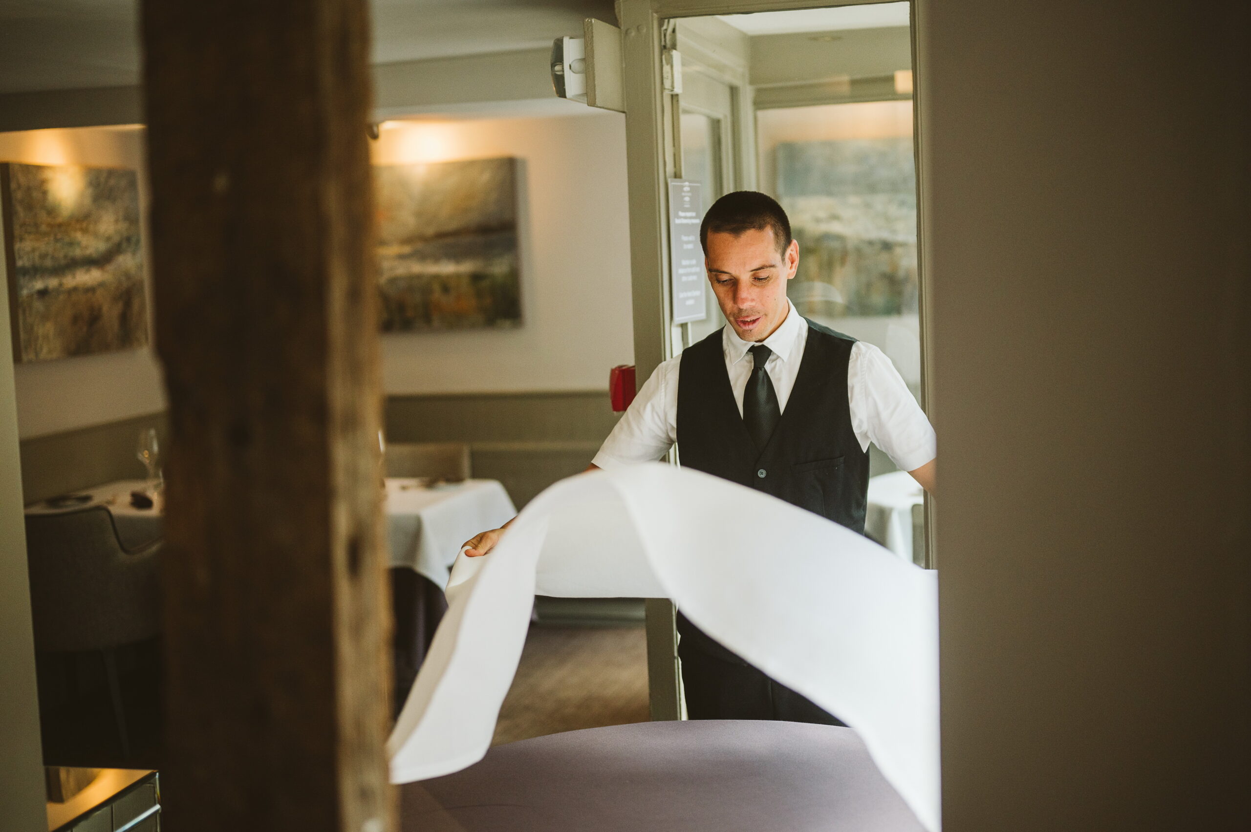 Waiter Sets a table in the restaurant